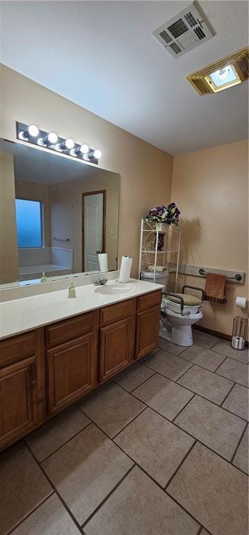 bathroom featuring tile patterned flooring, vanity, and toilet