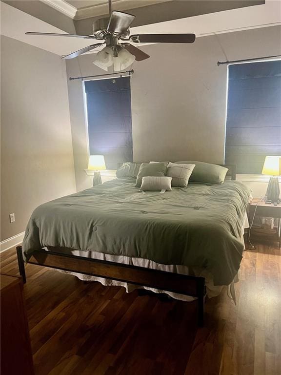 bedroom featuring ceiling fan, baseboards, and wood finished floors