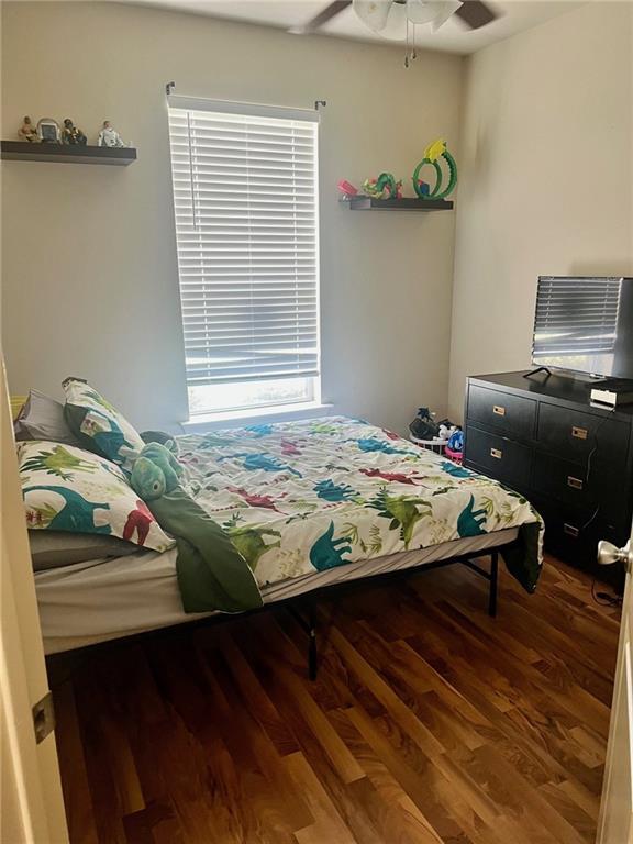 bedroom featuring wood finished floors and a ceiling fan