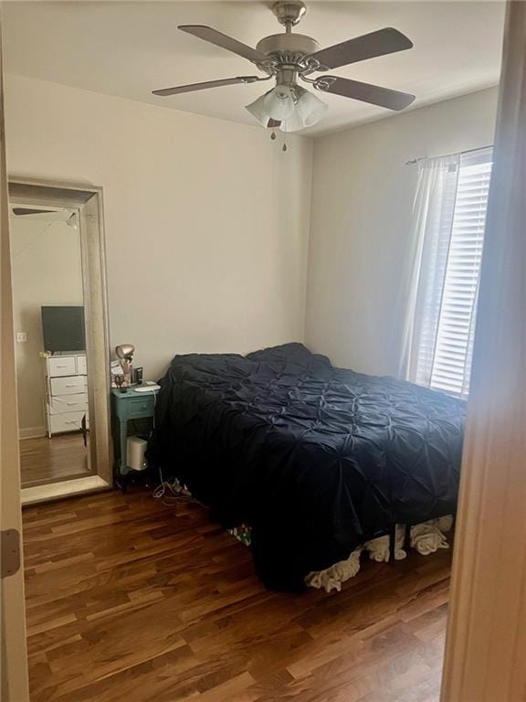 bedroom with a ceiling fan and wood finished floors