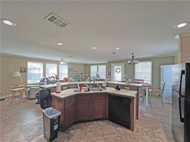 kitchen featuring stainless steel fridge, ceiling fan with notable chandelier, a kitchen island with sink, sink, and dishwasher