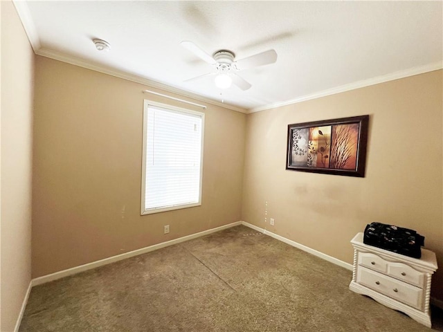 carpeted empty room featuring ceiling fan and ornamental molding