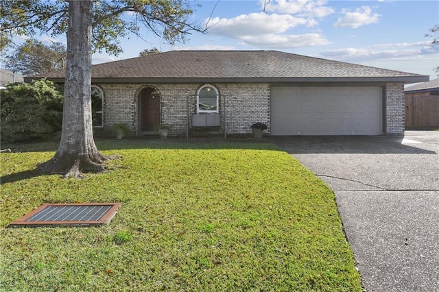 ranch-style house with a garage and a front lawn