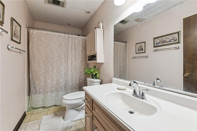 bathroom featuring tile patterned flooring, vanity, and toilet