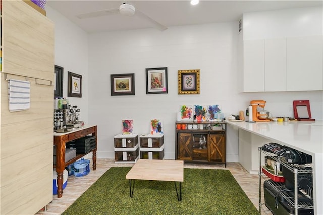 interior space with ceiling fan and light hardwood / wood-style flooring