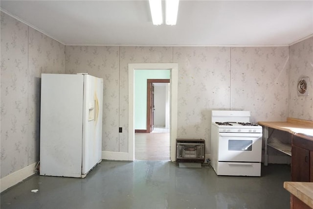 kitchen with white appliances, heating unit, concrete floors, and crown molding