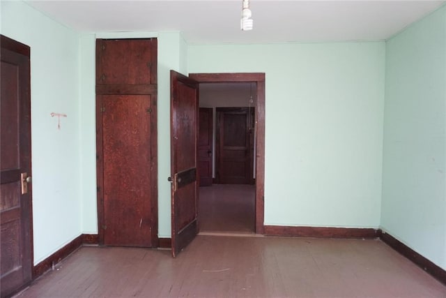 spare room featuring wood-type flooring