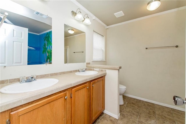 bathroom with vanity, toilet, and crown molding