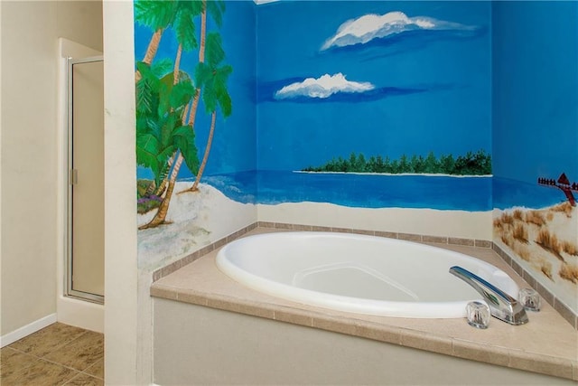 bathroom featuring tile patterned flooring and tiled bath