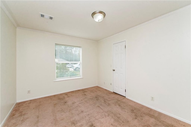 spare room featuring light carpet and ornamental molding