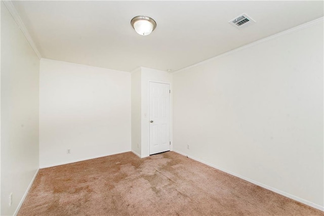 spare room with light carpet and crown molding