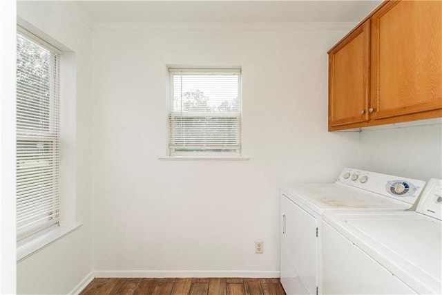 washroom featuring a healthy amount of sunlight, wood-type flooring, cabinets, and independent washer and dryer