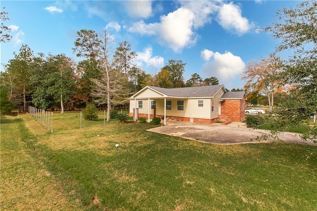 rear view of house featuring a patio area and a lawn