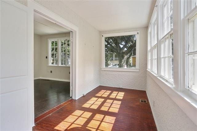 unfurnished sunroom with a healthy amount of sunlight