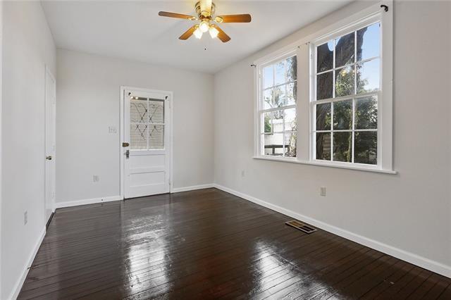 empty room featuring ceiling fan and dark hardwood / wood-style flooring