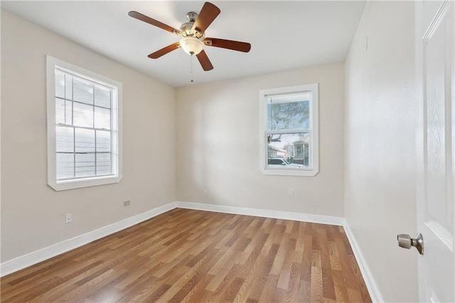 empty room with ceiling fan and light hardwood / wood-style floors