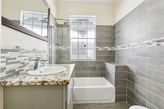 bathroom with vanity and tiled shower / bath combo