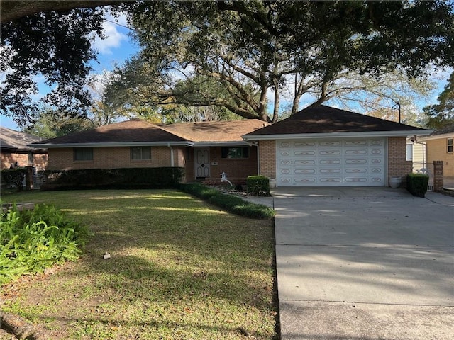 ranch-style house featuring a garage and a front lawn