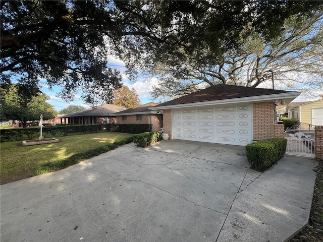 single story home with a garage and a front lawn