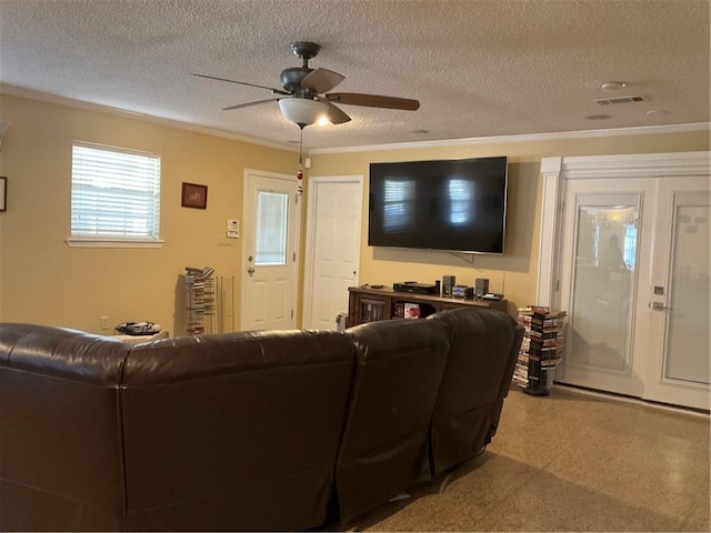 living room with crown molding, ceiling fan, and a textured ceiling