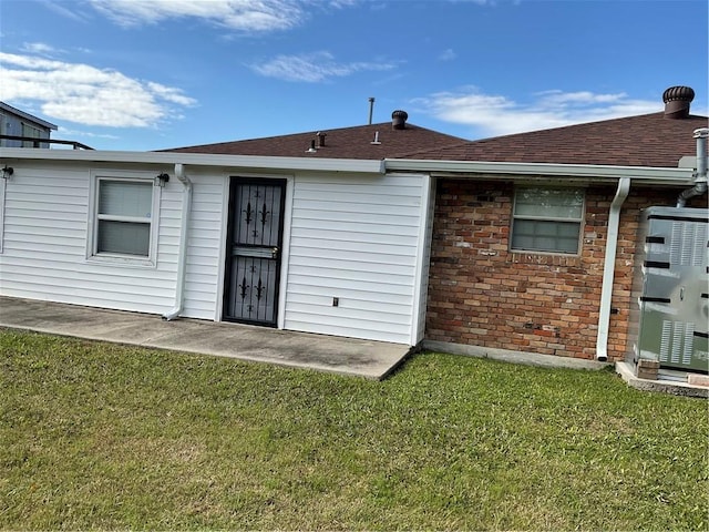 back of property with a patio area and a yard