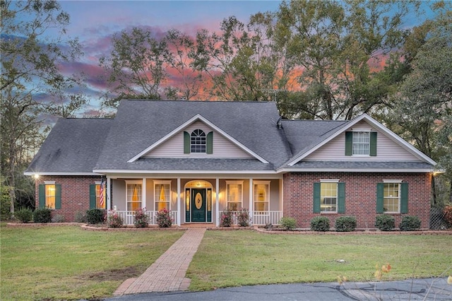 view of front of property featuring a lawn and a porch