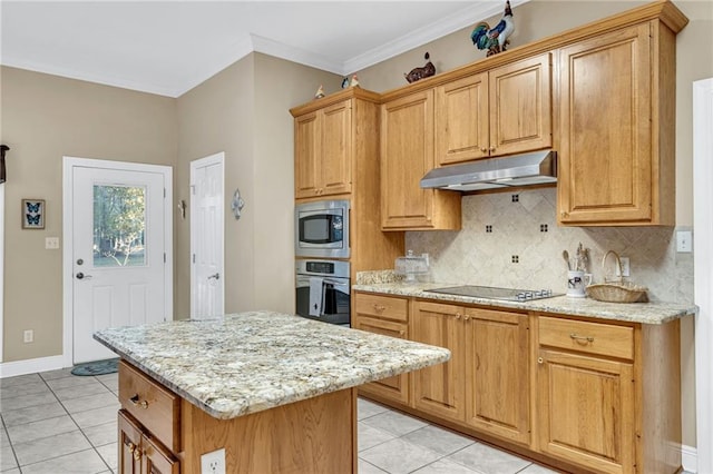 kitchen with a center island, light tile patterned floors, ornamental molding, light stone counters, and stainless steel appliances