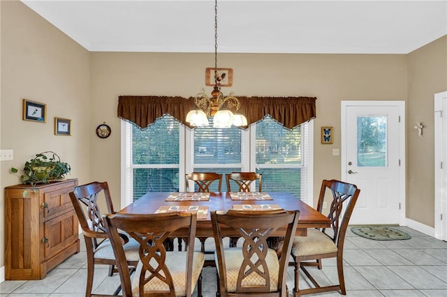 dining space featuring light tile patterned floors and a notable chandelier