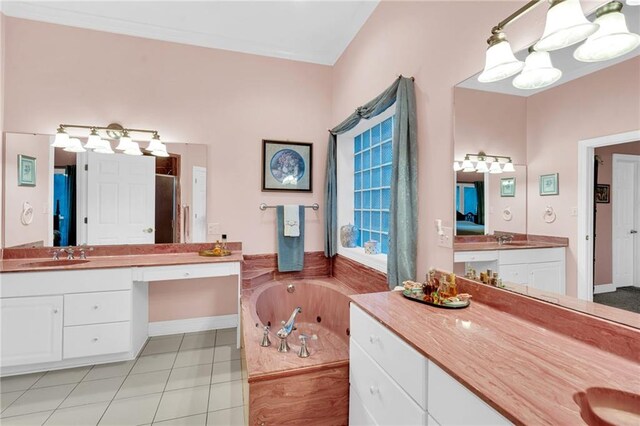 bathroom with tile patterned floors, vanity, and a washtub