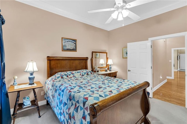 bedroom with light hardwood / wood-style floors, ceiling fan, and ornamental molding