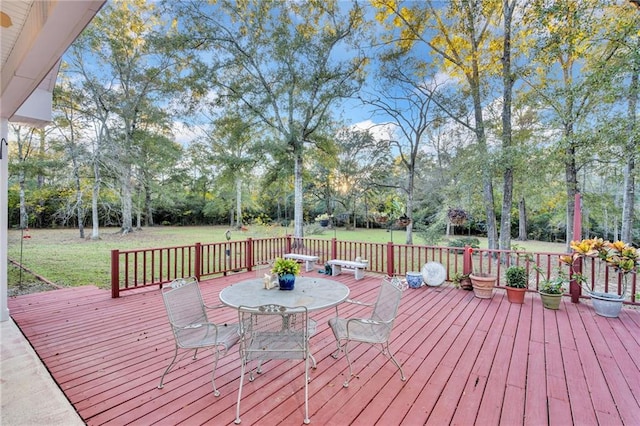 wooden terrace featuring a lawn