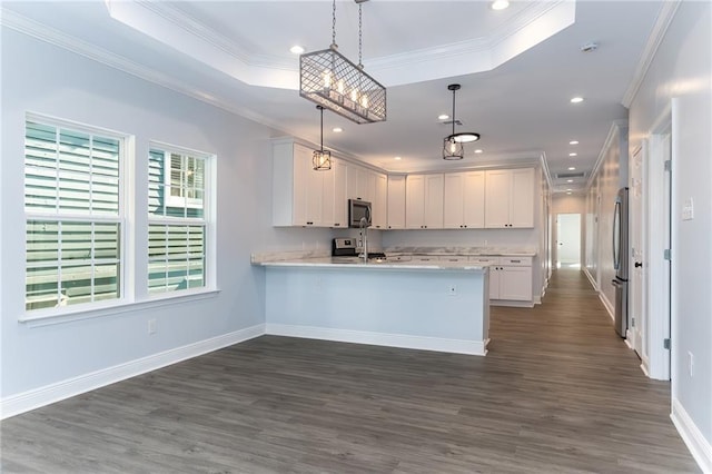 kitchen with kitchen peninsula, dark hardwood / wood-style flooring, white cabinetry, and hanging light fixtures