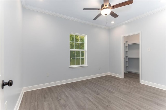 spare room featuring crown molding, ceiling fan, and hardwood / wood-style flooring