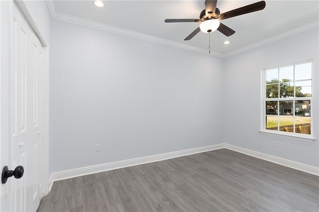 unfurnished room with ceiling fan, crown molding, and dark wood-type flooring