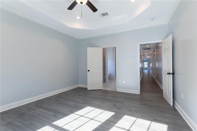 unfurnished bedroom featuring dark hardwood / wood-style floors, ceiling fan, and crown molding