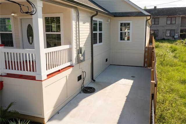 view of side of property with a patio and a balcony