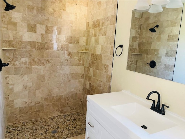 bathroom featuring vanity and tiled shower