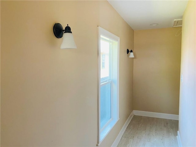 corridor with light hardwood / wood-style flooring