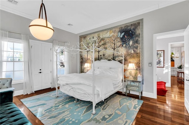 bedroom featuring dark hardwood / wood-style floors and ornamental molding