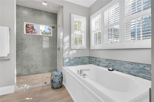 bathroom featuring separate shower and tub and wood-type flooring