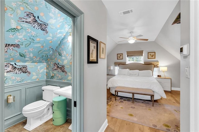 bedroom featuring ceiling fan, lofted ceiling, and light wood-type flooring