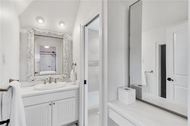 bathroom with vanity and vaulted ceiling