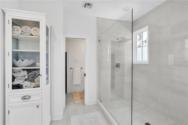 bathroom with a tile shower