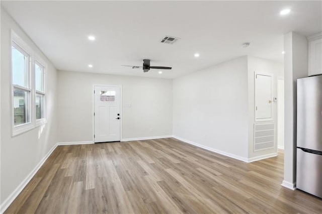 spare room featuring ceiling fan and light wood-type flooring