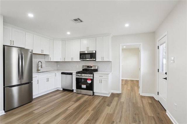 kitchen with white cabinets, stainless steel appliances, and sink