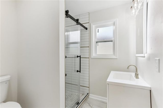 bathroom with vanity, toilet, and a shower with door