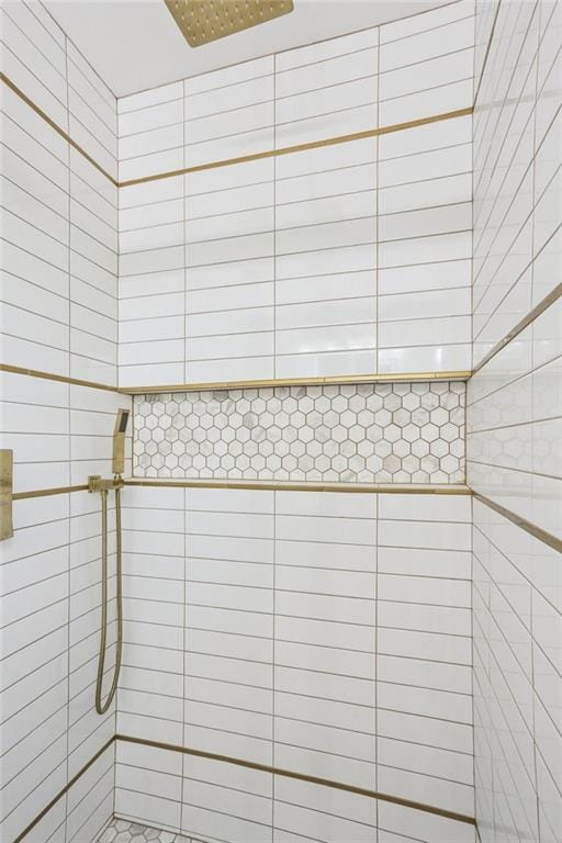 bathroom with tiled shower