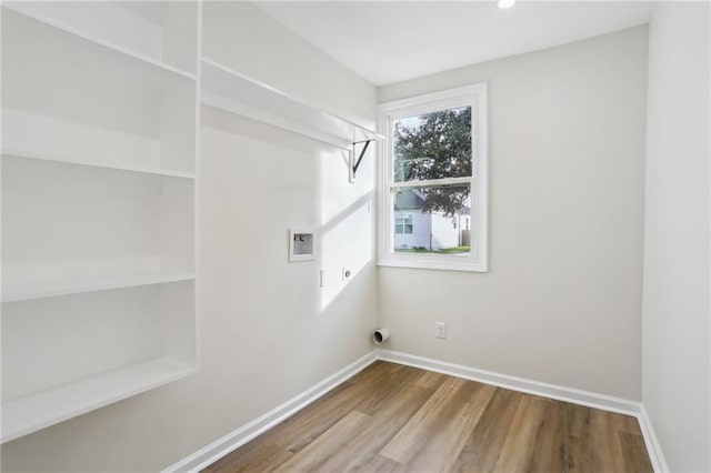 laundry area with electric dryer hookup, hookup for a washing machine, and hardwood / wood-style flooring