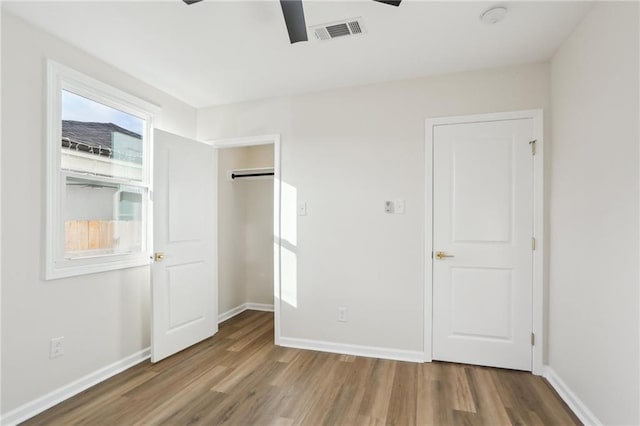 unfurnished bedroom featuring wood-type flooring and ceiling fan