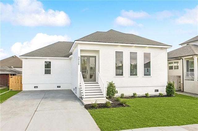 view of front of home with a front lawn and french doors